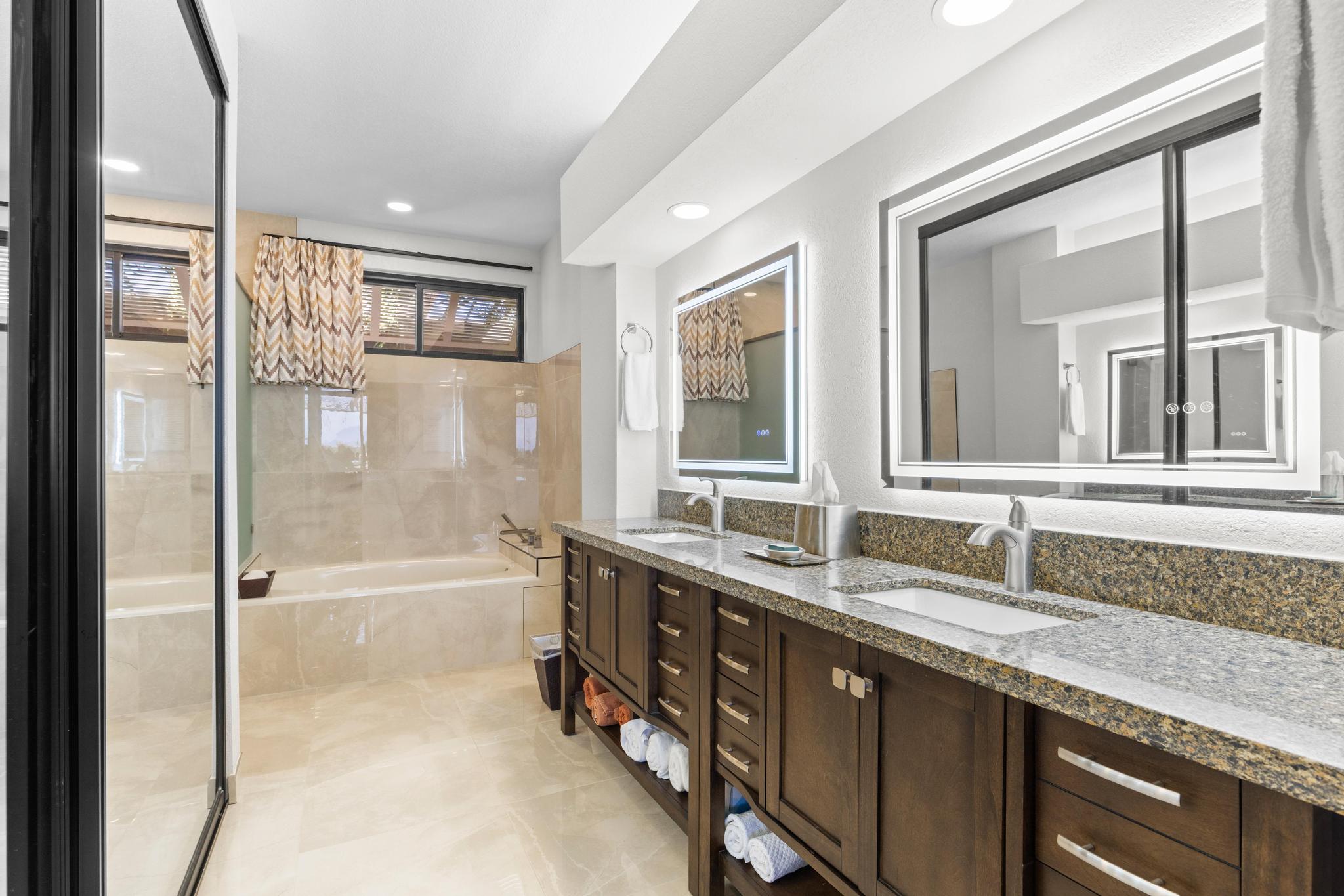 69-450 Bay Club, Unit 236 Waikoloa, HI 96738 - Photo 13 of 22 a bathroom with a granite countertop sink mirror bathtub and shower
