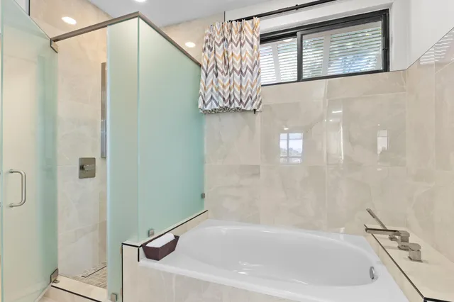 a bathroom with a bathtub and a shower