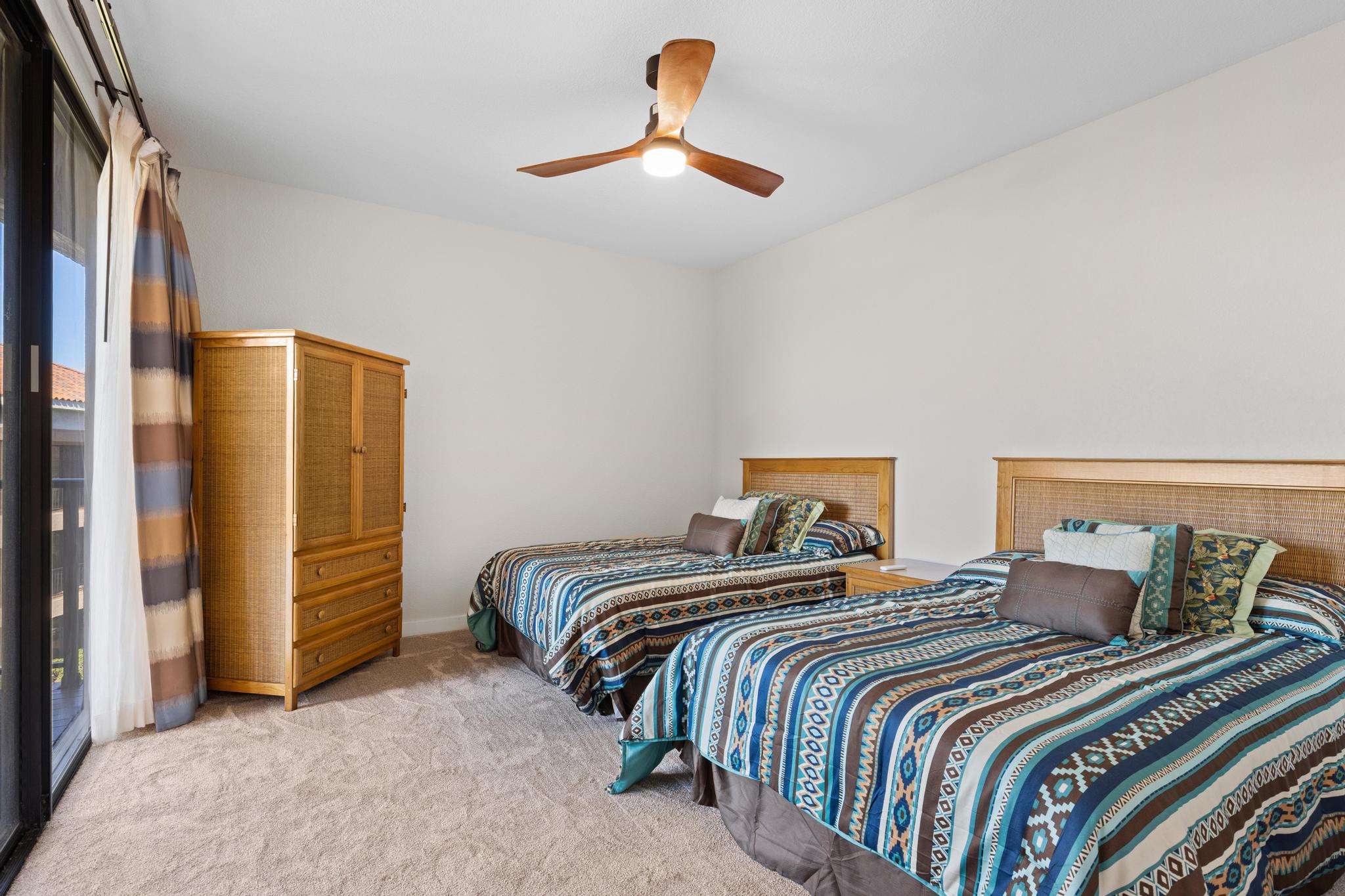 69-450 Bay Club, Unit 236 Waikoloa, HI 96738 - Photo 16 of 22 a bedroom with a bed and a chandelier