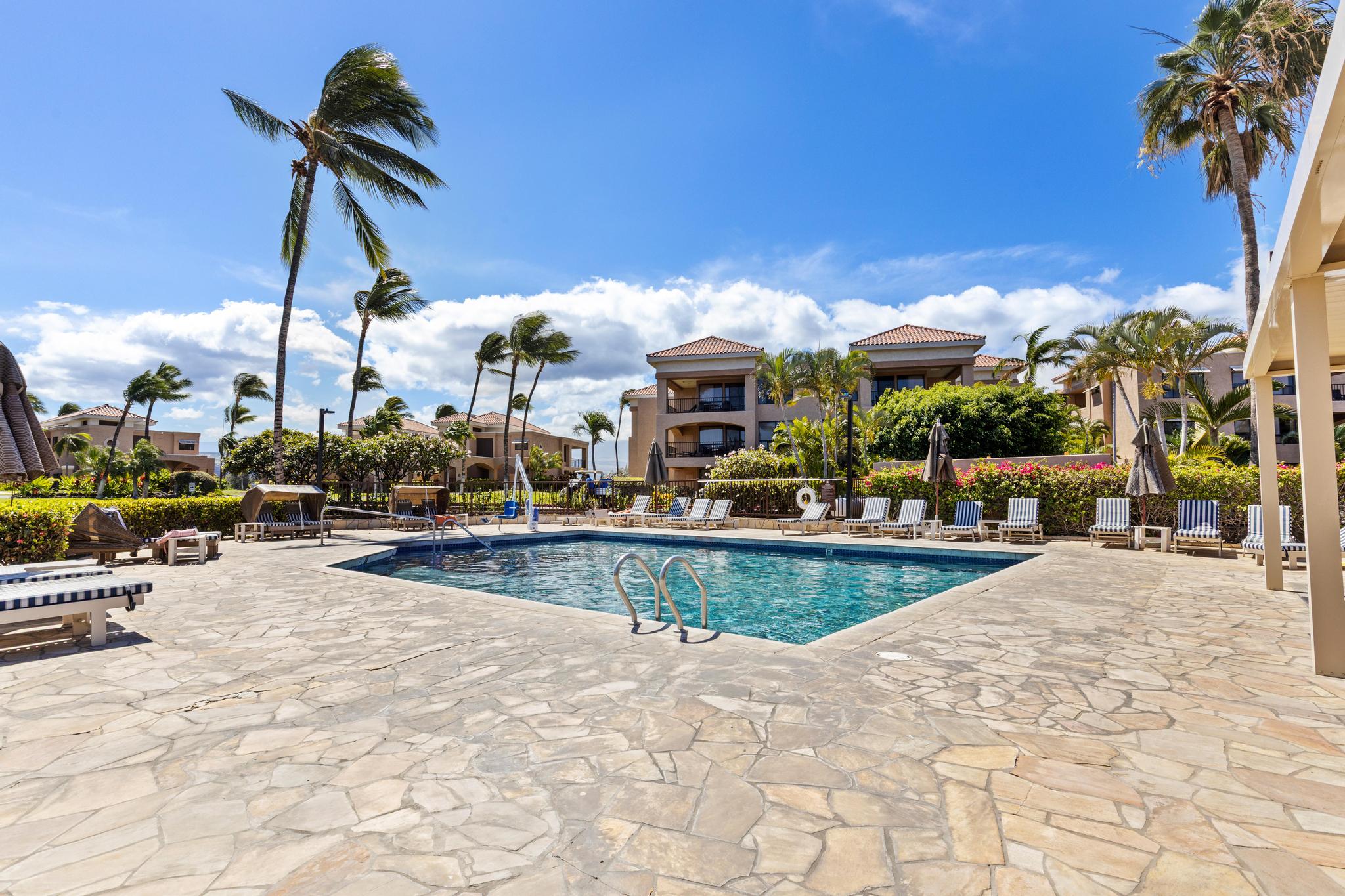 69-450 Bay Club, Unit 236 Waikoloa, HI 96738 - Photo 20 of 22 a view of a swimming pool with a lounge chairs