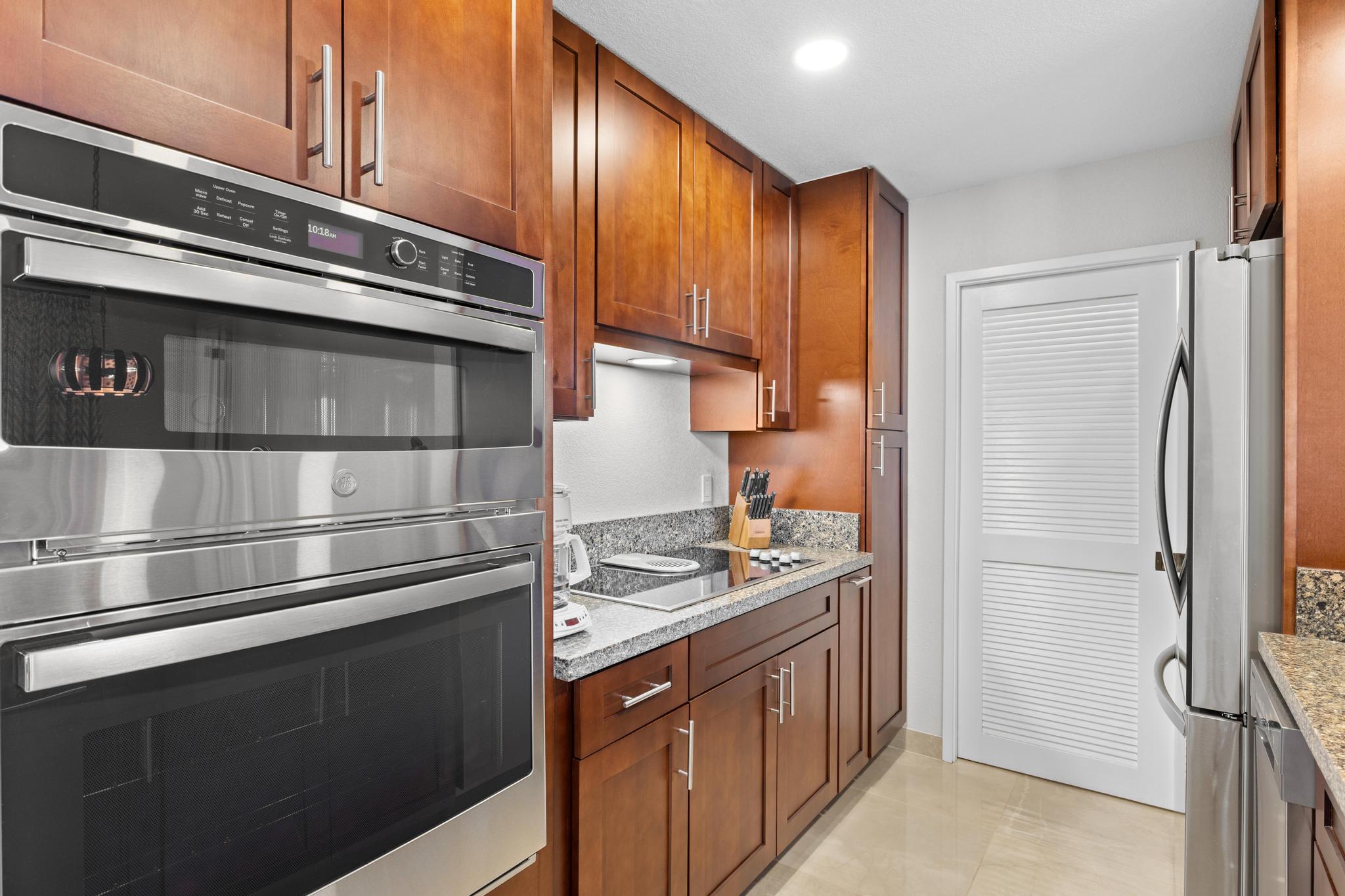 69-450 Bay Club, Unit 236 Waikoloa, HI 96738 - Photo 5 of 22 a kitchen with stainless steel appliances granite countertop a refrigerator and a stove top oven