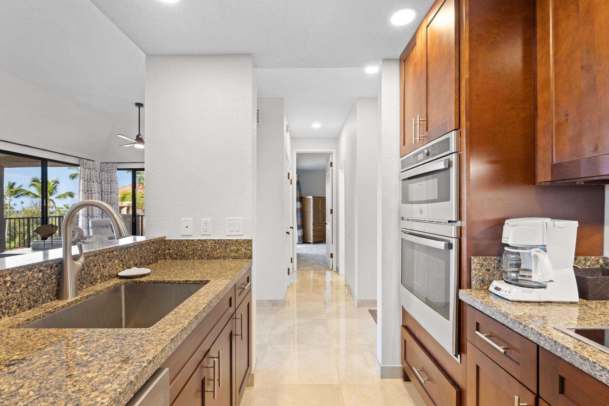 69-450 Bay Club, Unit 236 Waikoloa, HI 96738 - Photo 7 of 22 a kitchen with a sink stove and refrigerator