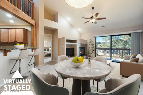 a view of a dining room with furniture and a table and chairs