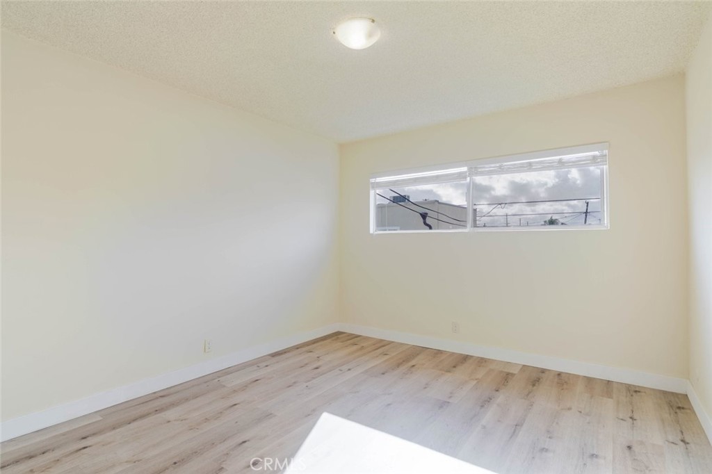 4012 West 133rd Street, Unit 8 Hawthorne, CA 90250 - Photo 13 of 20 an empty room with wooden floor and windows