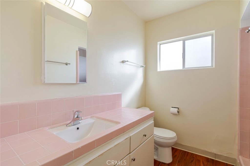 4012 West 133rd Street, Unit 8 Hawthorne, CA 90250 - Photo 15 of 20 a bathroom with a sink a toilet and mirror