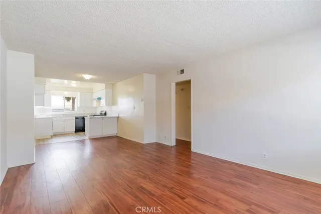a view of a kitchen with wooden floor and a kitchen