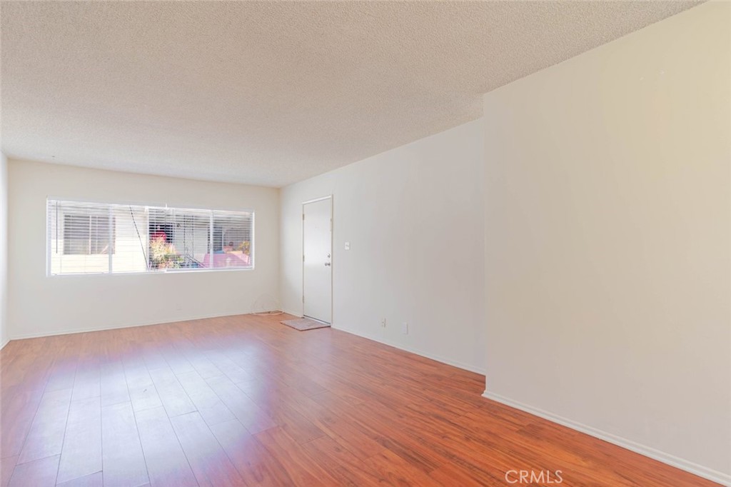 4012 West 133rd Street, Unit 8 Hawthorne, CA 90250 - Photo 6 of 20 an empty room with wooden floor and windows