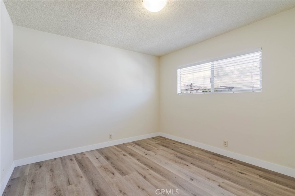 4012 West 133rd Street, Unit 8 Hawthorne, CA 90250 - Photo 8 of 20 an empty room with wooden floor and windows
