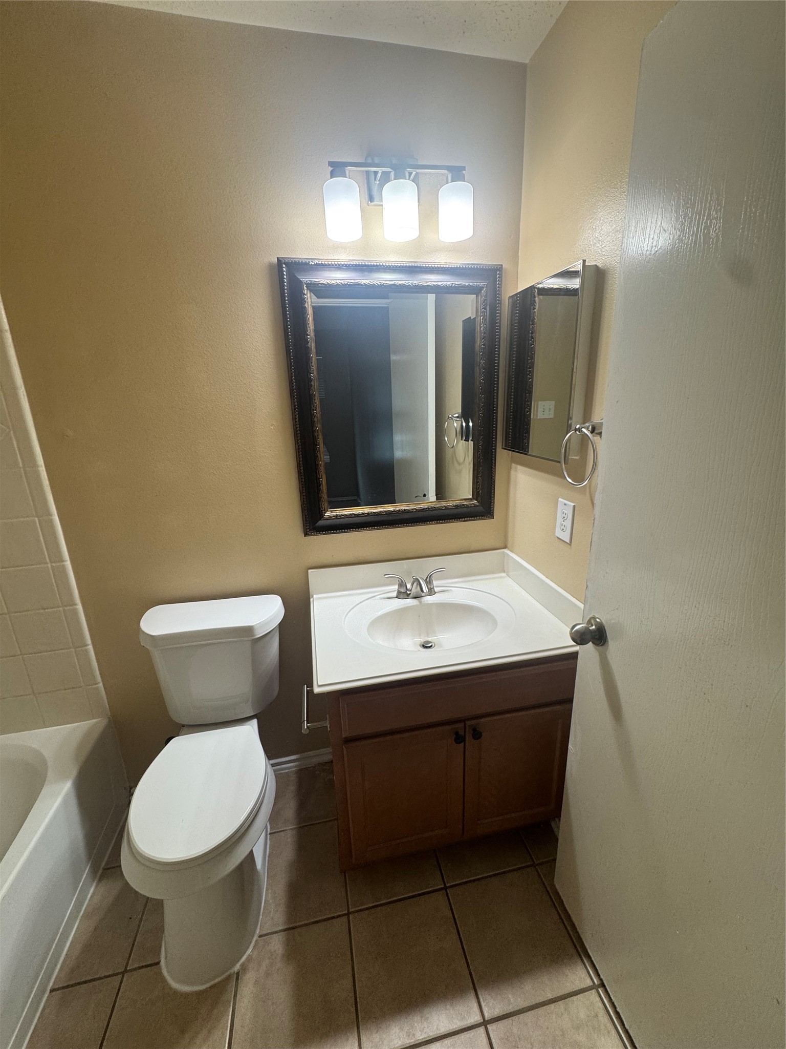 10906 View Pointe Lane Houston, TX 77034 - Photo 9 of 9 a bathroom with a toilet sink and mirror