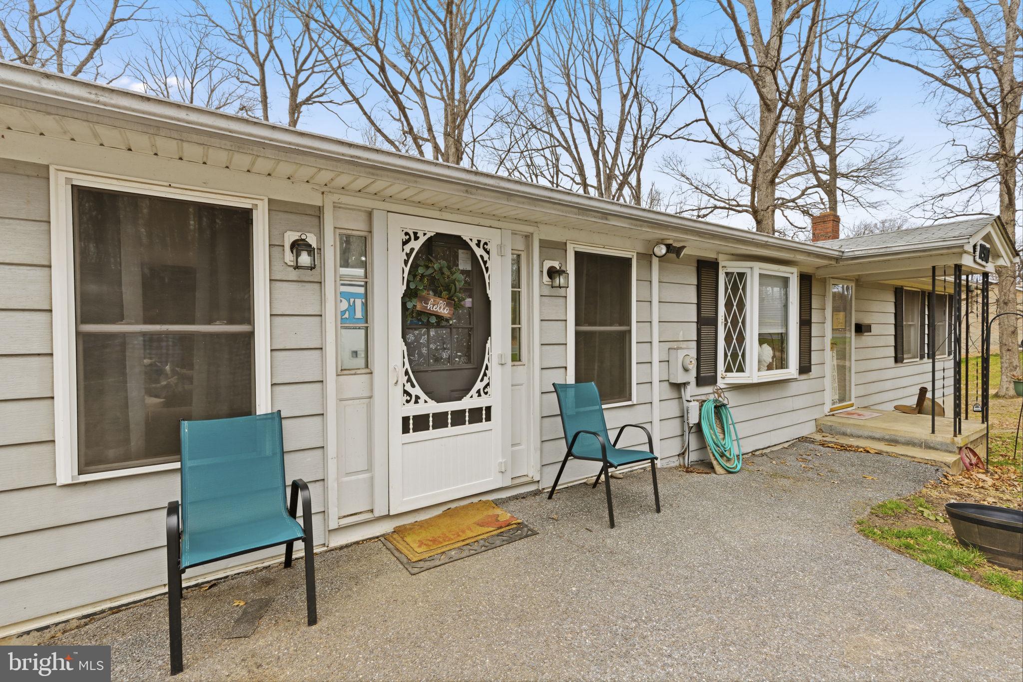 11910 Warner Road Keymar, MD 21757 - Photo 4 of 51 a front view of a house with outdoor seating and a large window