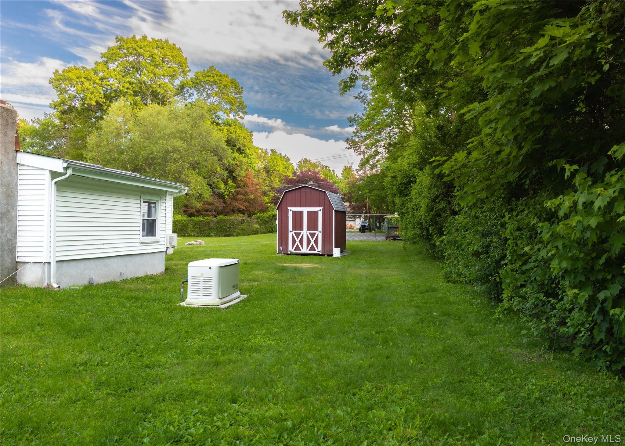 23 Lucille Road Carmel, NY 10512 - Photo 29 of 44 a view of a back yard of the house with a fountain