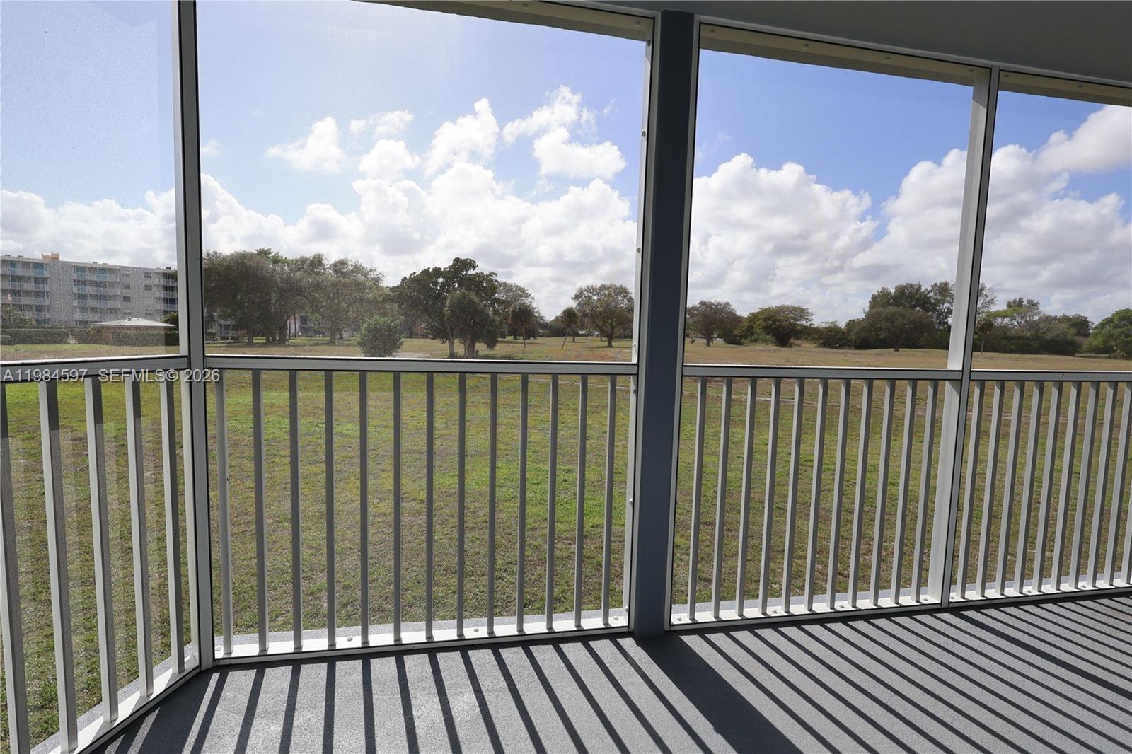 5301 Northwest 2nd Avenue, Unit 203 Boca Raton, FL 33487 - Photo 11 of 17 a view of a balcony with a floor to ceiling window wooden floor