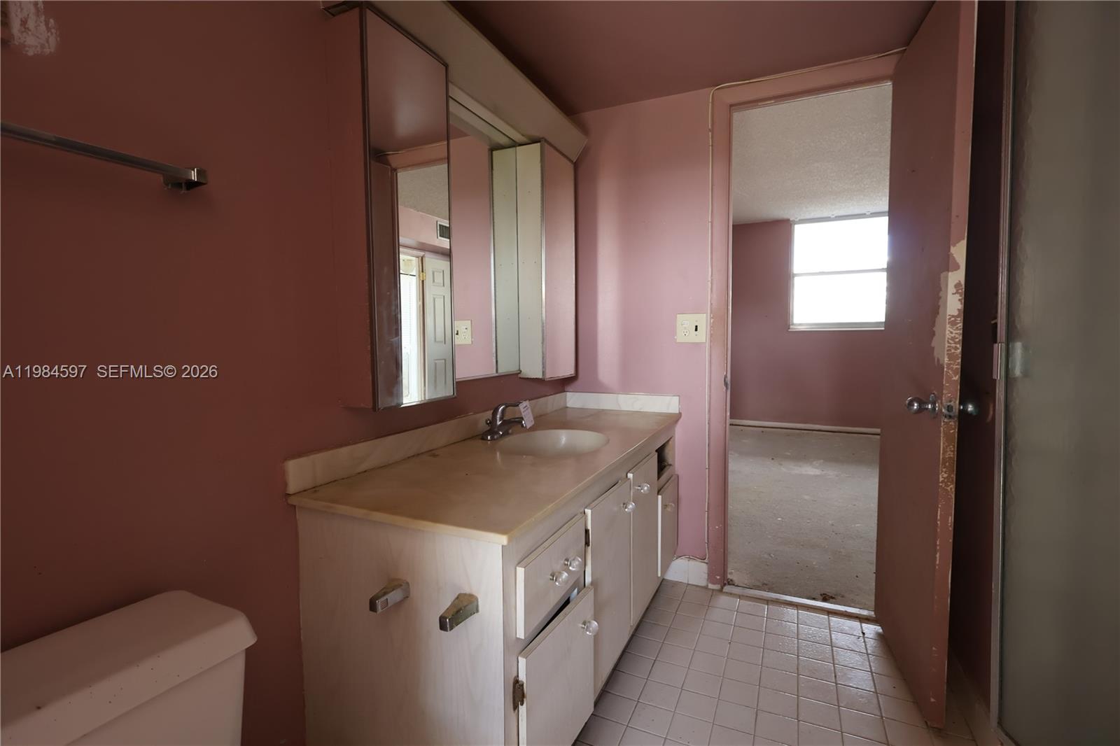 5301 Northwest 2nd Avenue, Unit 203 Boca Raton, FL 33487 - Photo 15 of 17 a bathroom with a granite countertop sink and a mirror