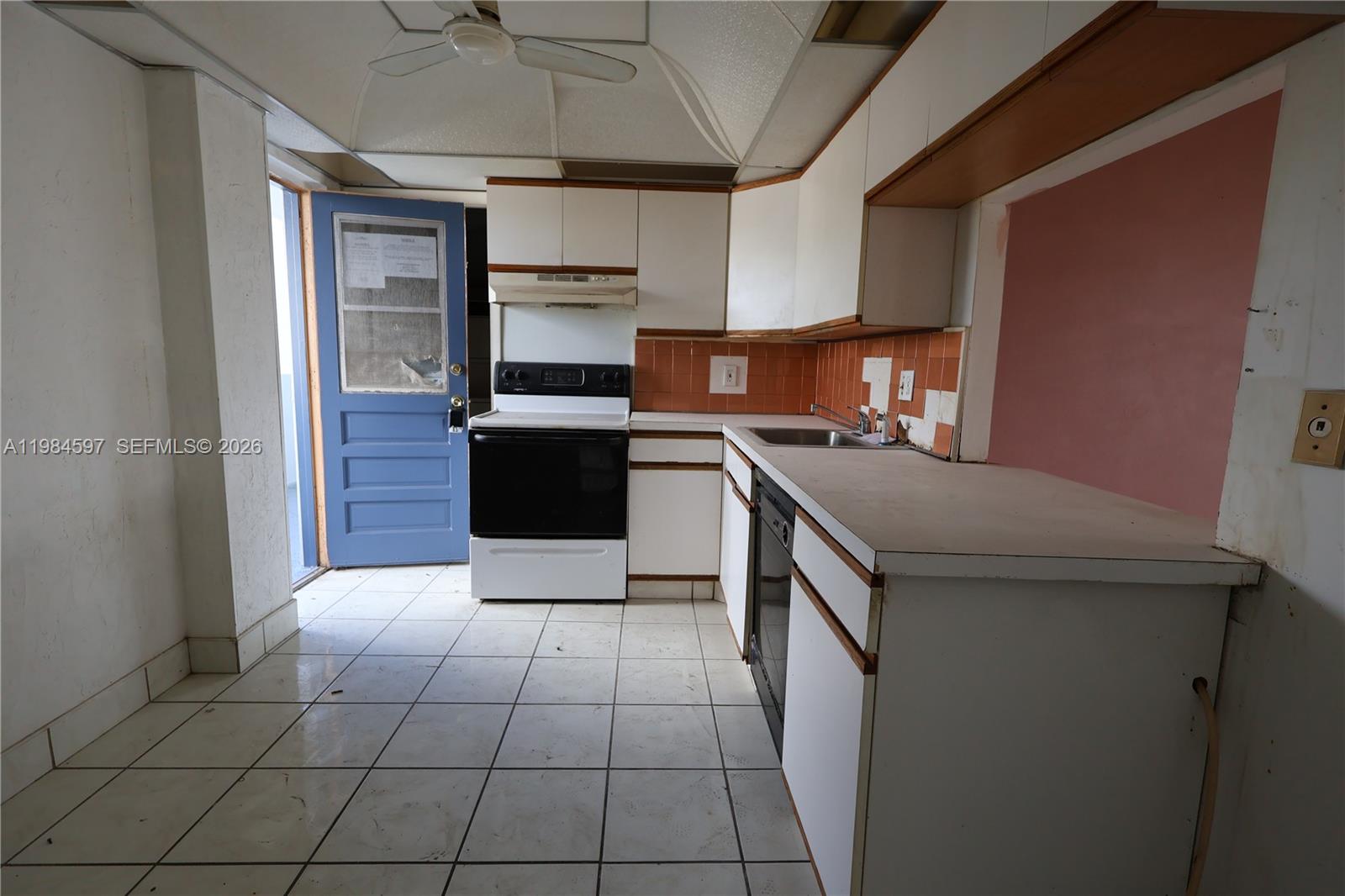 5301 Northwest 2nd Avenue, Unit 203 Boca Raton, FL 33487 - Photo 3 of 17 a kitchen with a sink cabinets and stainless steel appliances