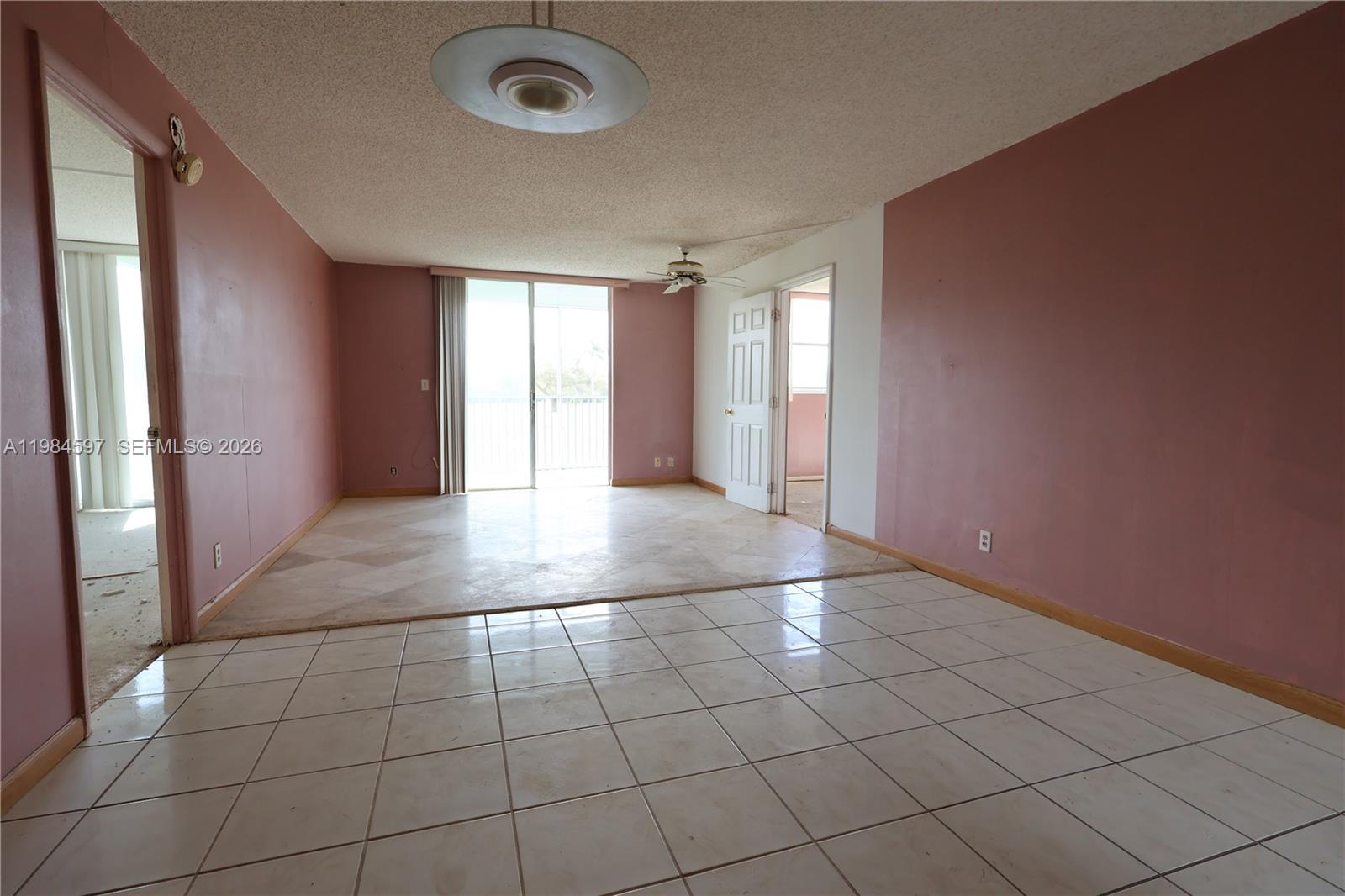 5301 Northwest 2nd Avenue, Unit 203 Boca Raton, FL 33487 - Photo 5 of 17 an empty room with a empty space and windows