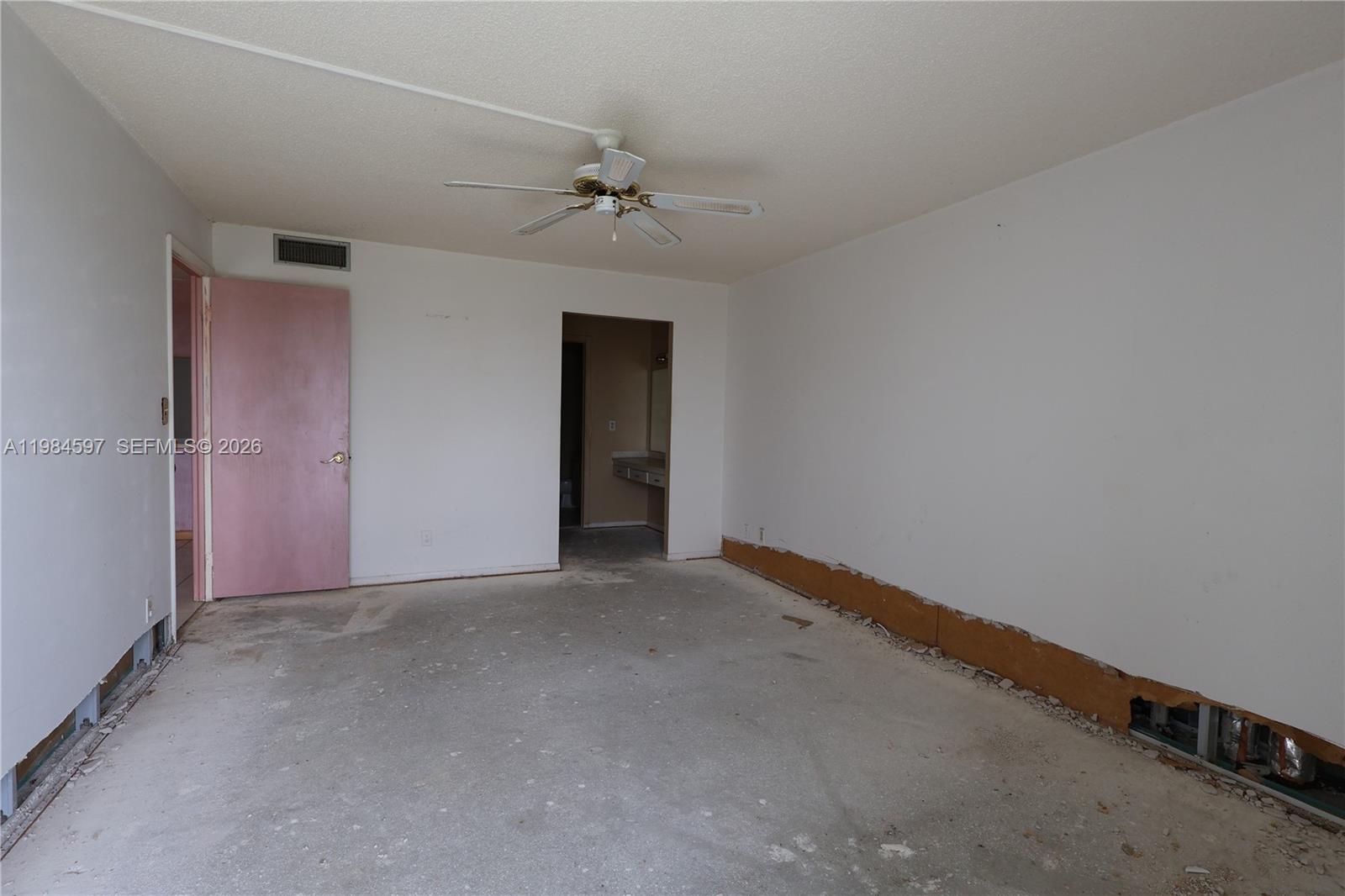 5301 Northwest 2nd Avenue, Unit 203 Boca Raton, FL 33487 - Photo 8 of 17 an empty room with a ceiling fan