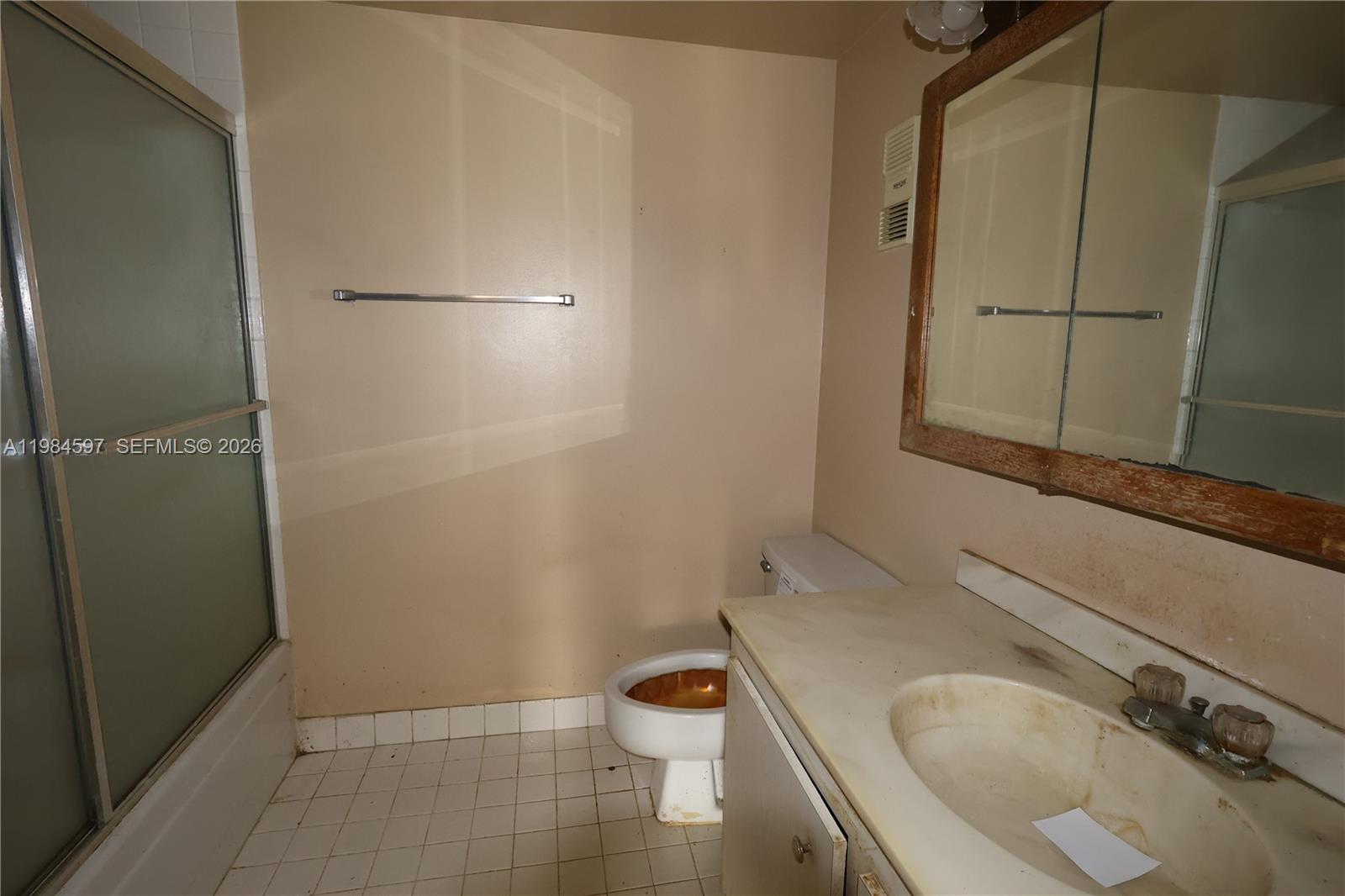 5301 Northwest 2nd Avenue, Unit 203 Boca Raton, FL 33487 - Photo 9 of 17 a bathroom with a granite countertop sink toilet and shower