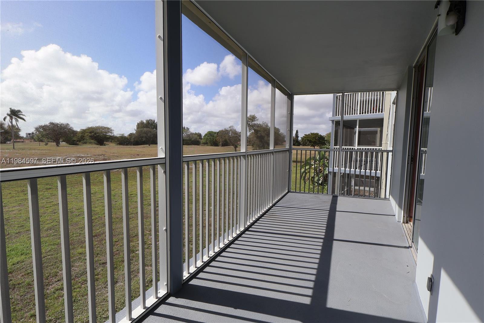 5301 Northwest 2nd Avenue, Unit 203 Boca Raton, FL 33487 - Photo 10 of 17 a view of a balcony with wooden floor