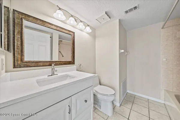 a bathroom with a toilet a sink and a mirror