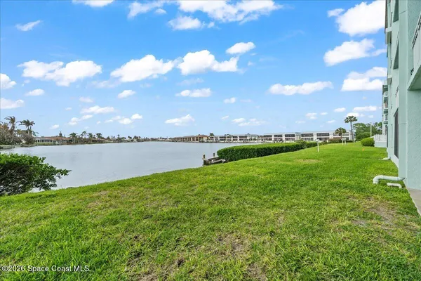 a view of a lake with houses in the back