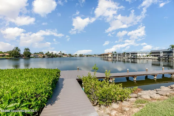 a view of a lake with houses in the back
