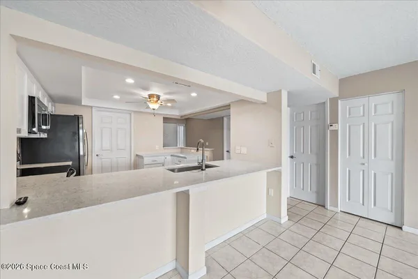 a large kitchen with kitchen island a sink stainless steel appliances and cabinets