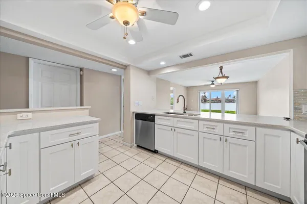 a large white kitchen with a white cabinets