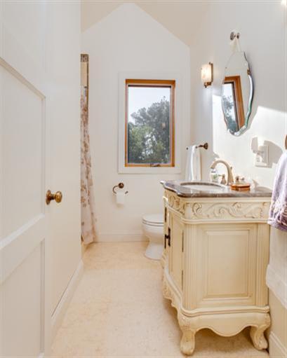 4230 Thacher Road Ojai, CA 93023 - Photo 19 of 22 a bathroom with a granite countertop sink mirror vanity and toilet
