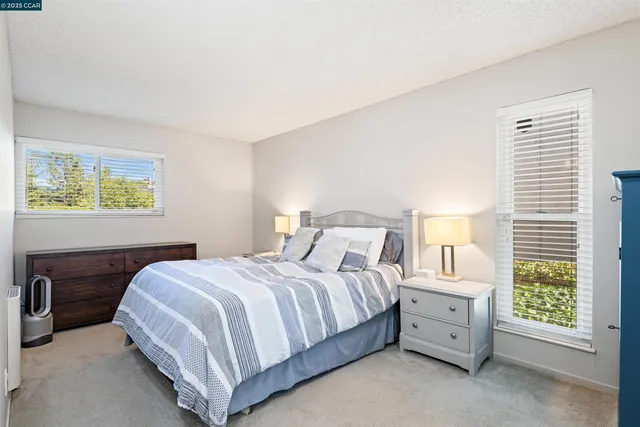 a bedroom with a bed and a night stand