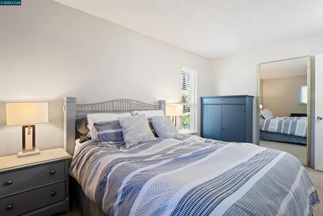 a bedroom with a bed and a lamp