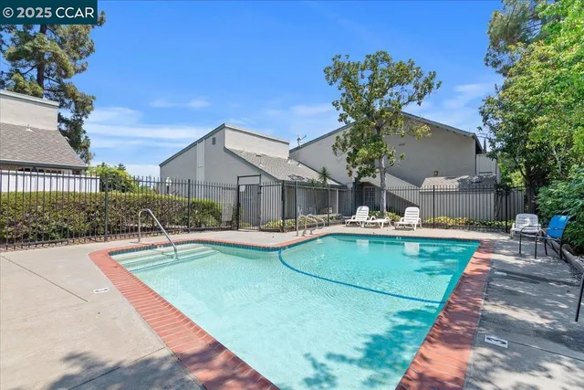 a view of a house with swimming pool and sitting area