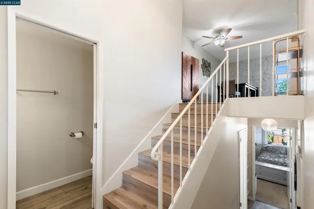 a view of entryway and hall with wooden floor
