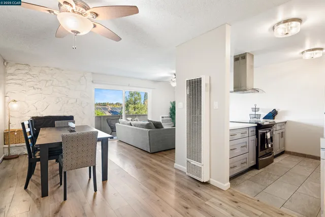 a kitchen with a table chairs refrigerator and microwave