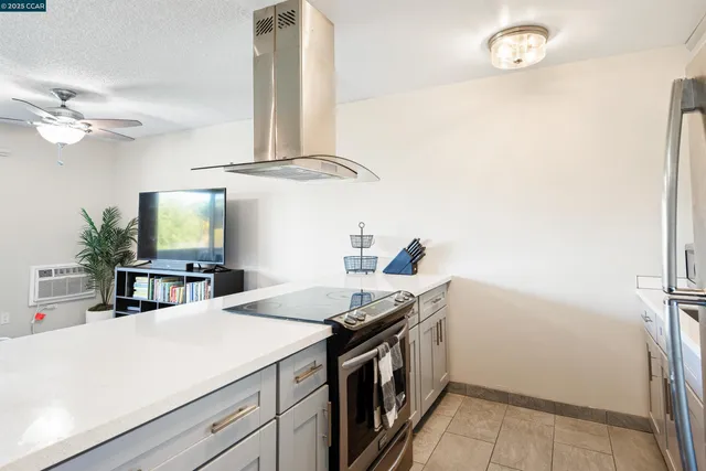 a kitchen with a sink dishwasher a stove and a refrigerator with wooden floor