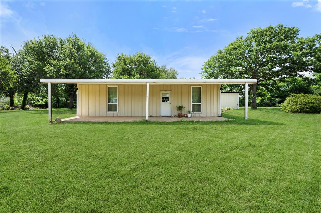 Cute home with mature trees and over 40 foot long front and back covered patio