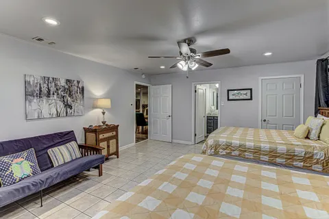 a bedroom with a bed and a lamp