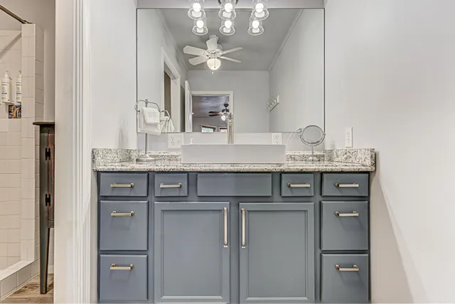 a backyard of a house with a large tree and outdoor seating