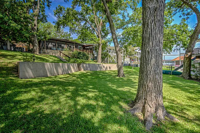 a view of a wooden deck with a yard