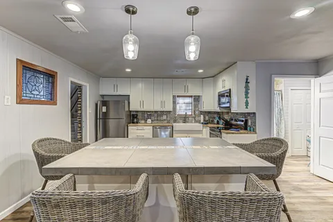 a living room with furniture kitchen view and a fireplace