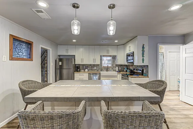 a living room with furniture kitchen view and a fireplace
