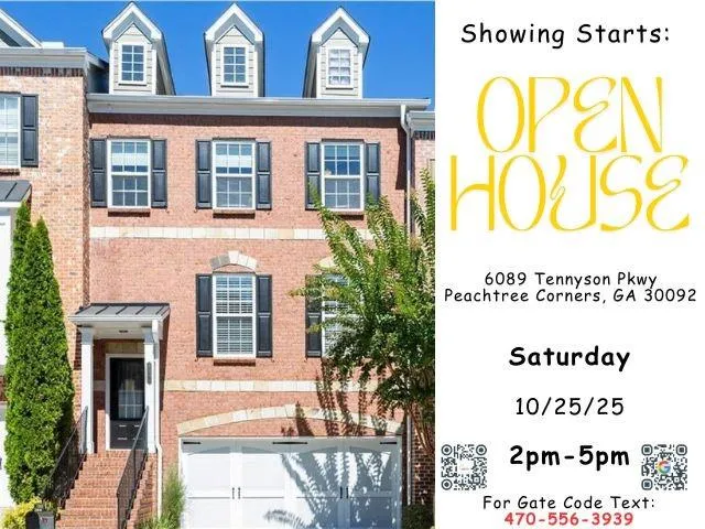 a view of a brick house with a large windows and flower plants