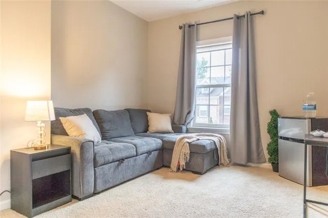 a large bed sitting in a bedroom next to a window
