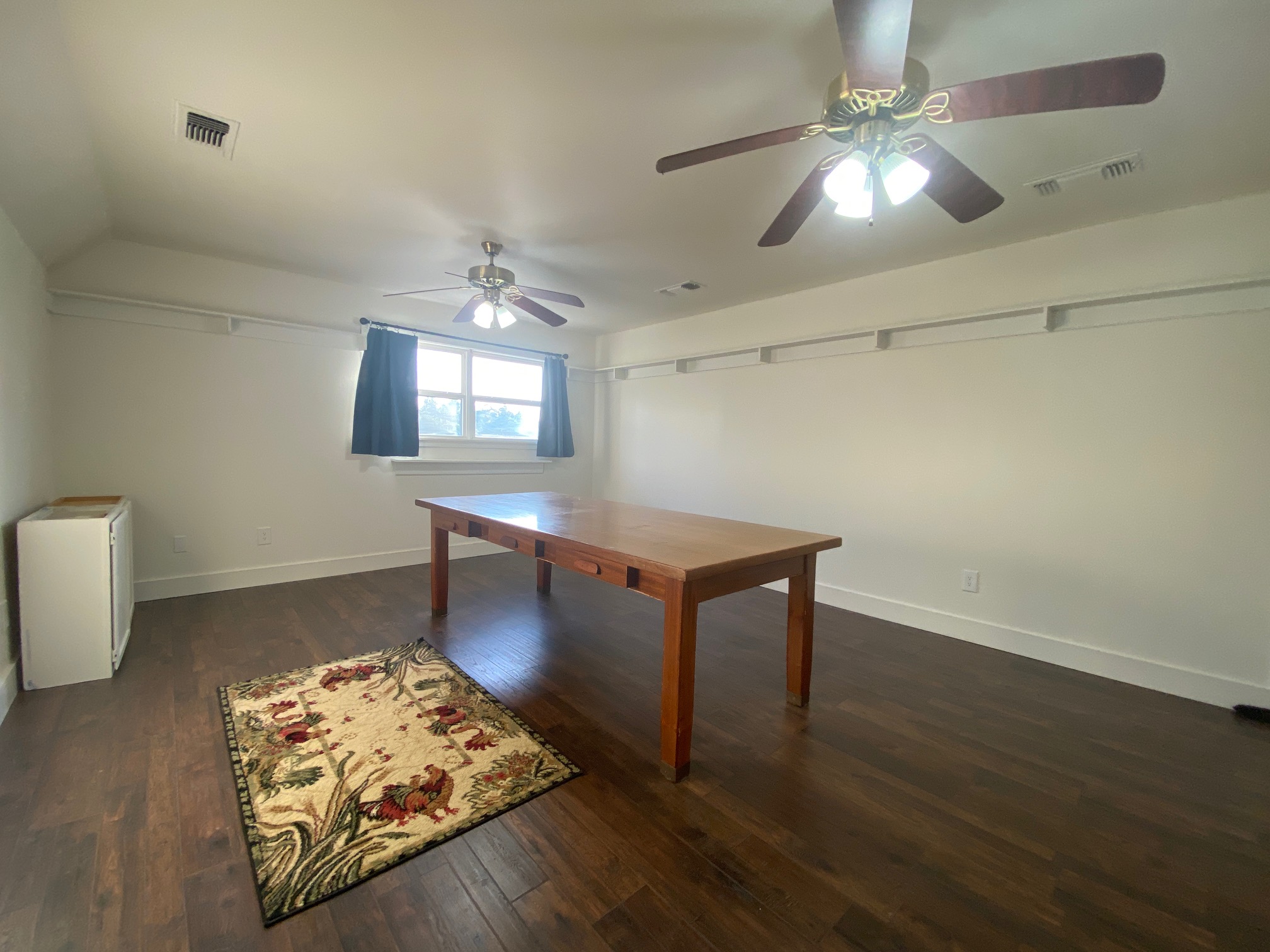 306 Plainview Road Wimberley, TX 78676 - Photo 19 of 29 A versatile room with wood flooring and attic access for storage.