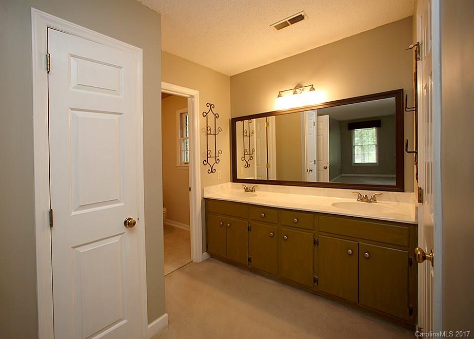 124 Friendfield Drive, Unit 10 Fort Mill, SC 29715 - Photo 12 of 24 a bathroom with a double vanity sink and a mirror