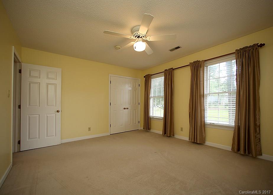 124 Friendfield Drive, Unit 10 Fort Mill, SC 29715 - Photo 15 of 24 a view of an empty room with window and chandelier fan