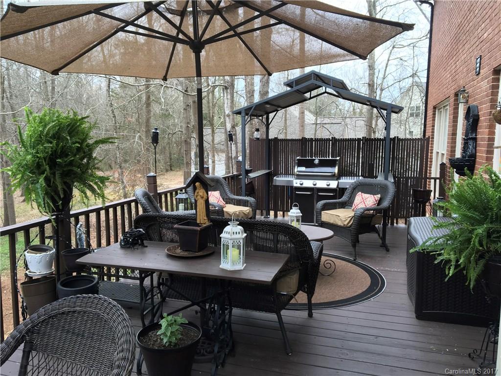 124 Friendfield Drive, Unit 10 Fort Mill, SC 29715 - Photo 24 of 24 a roof deck with table and chairs under an umbrella