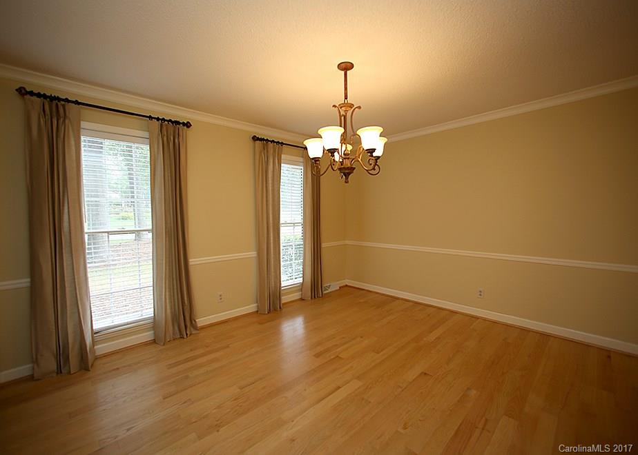 124 Friendfield Drive, Unit 10 Fort Mill, SC 29715 - Photo 10 of 24 a view of a livingroom with a chandelier fan and windows