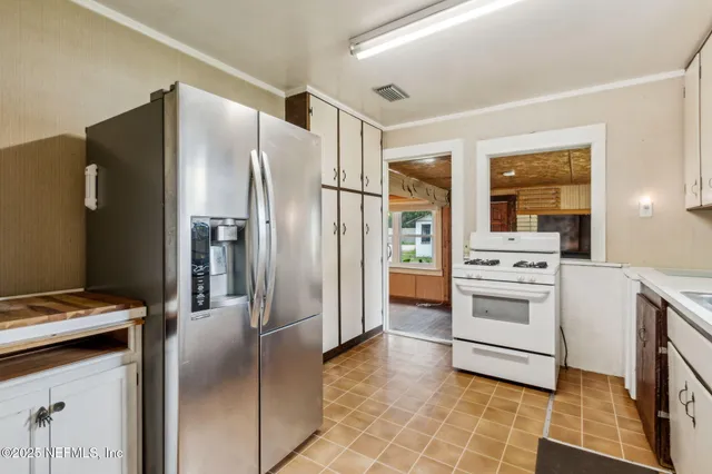 a kitchen with stainless steel appliances a refrigerator sink and stove