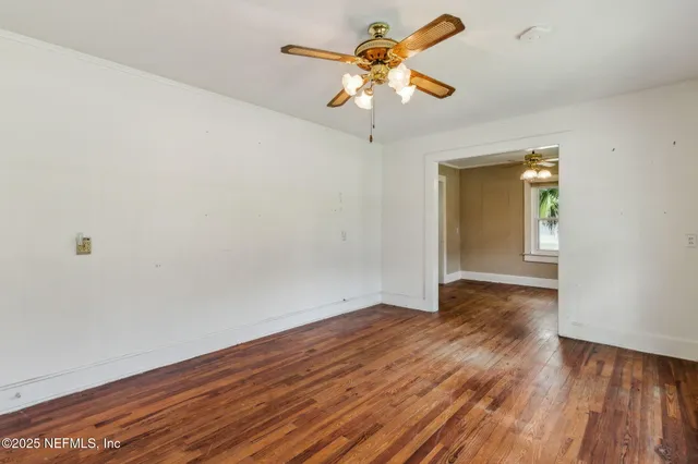 wooden floor in an empty room with a window