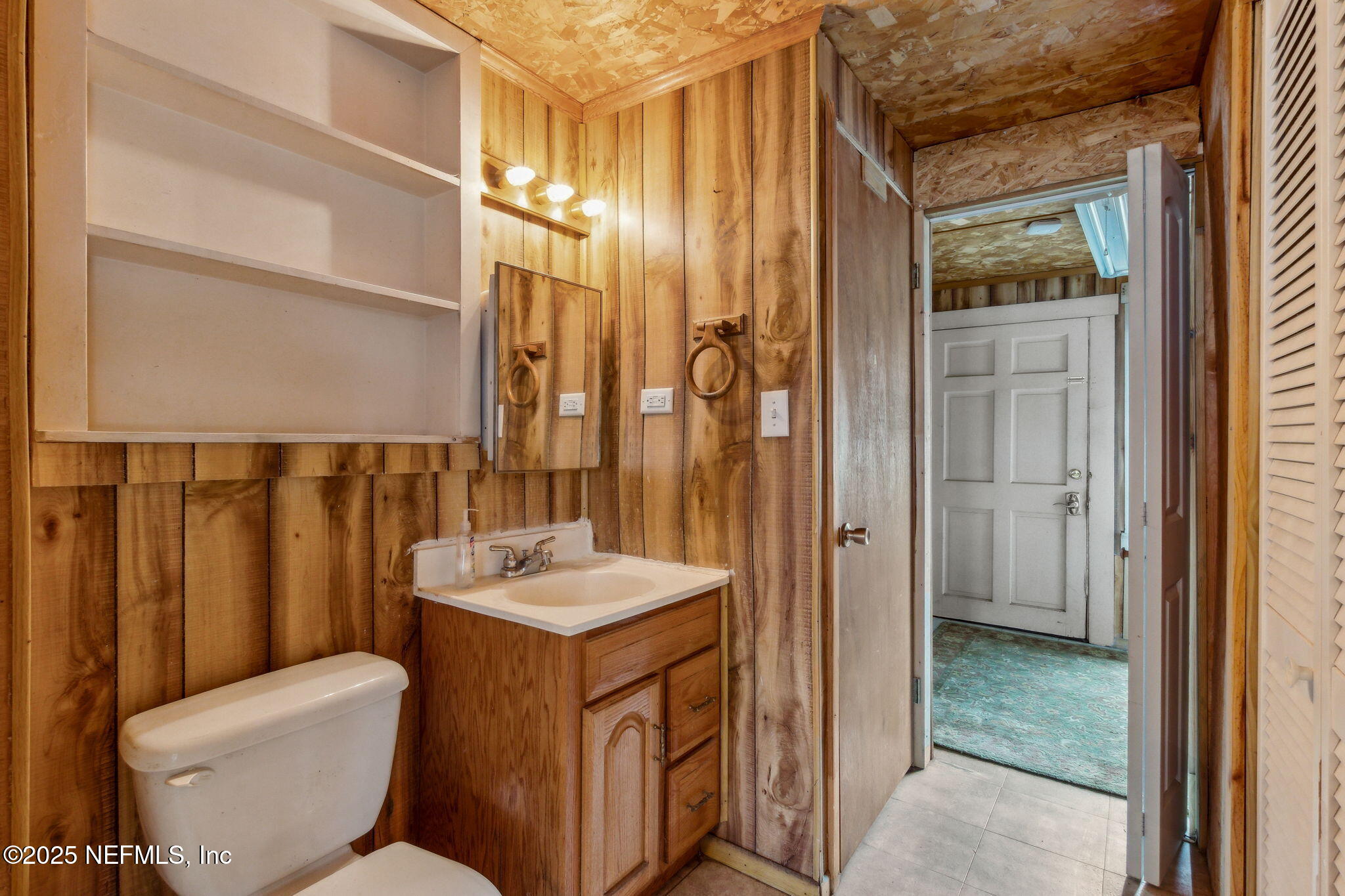 2753 Amelia Road Fernandina Beach, FL 32034 - Photo 14 of 40 a bathroom with a granite countertop sink toilet and shower
